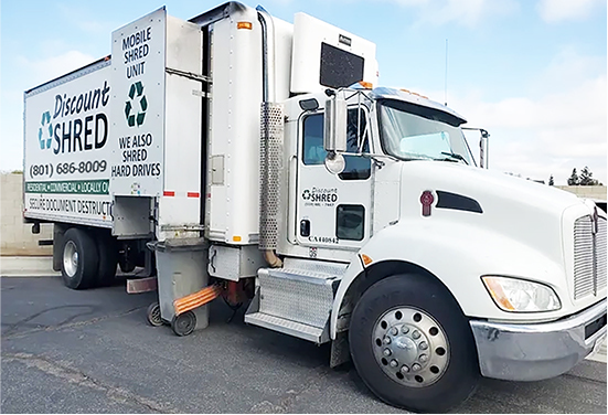shredding truck arrives to pick up shredding bins.